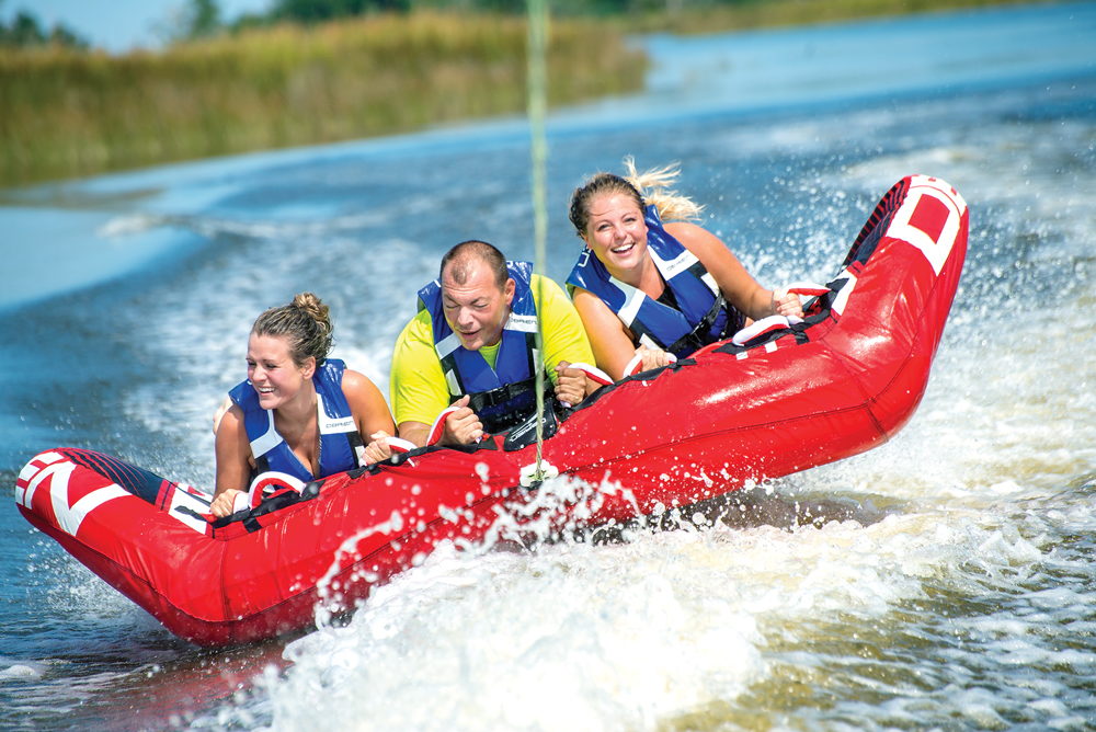 Three riders enjoying their tubing ride with Nor’Banks Sailing & Watersports